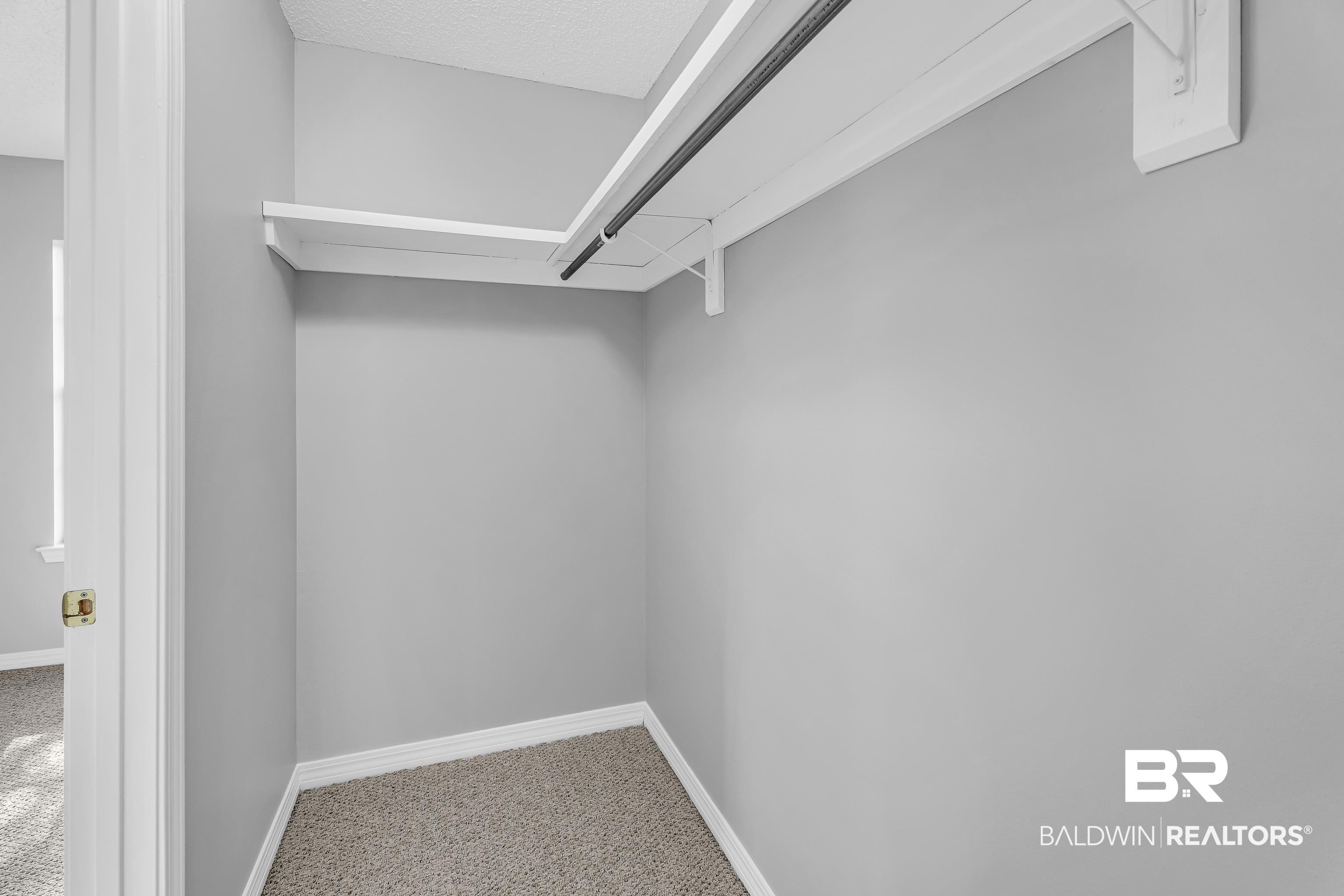 7787 Bellingrath Road Theodore, AL 36582 - Photo 23 of 36 Walk in closet with carpet flooring