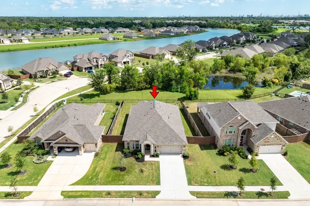 an aerial view of a house with garden space and ocean view