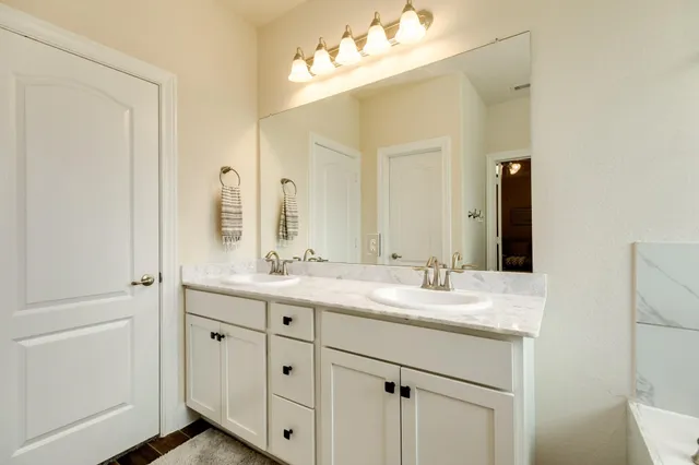 a bathroom with a sink vanity and mirror