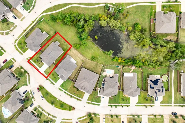 an aerial view of residential houses with outdoor space and street view