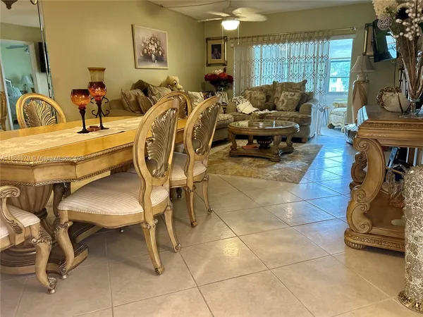 a living room with patio chairs and a gym machine
