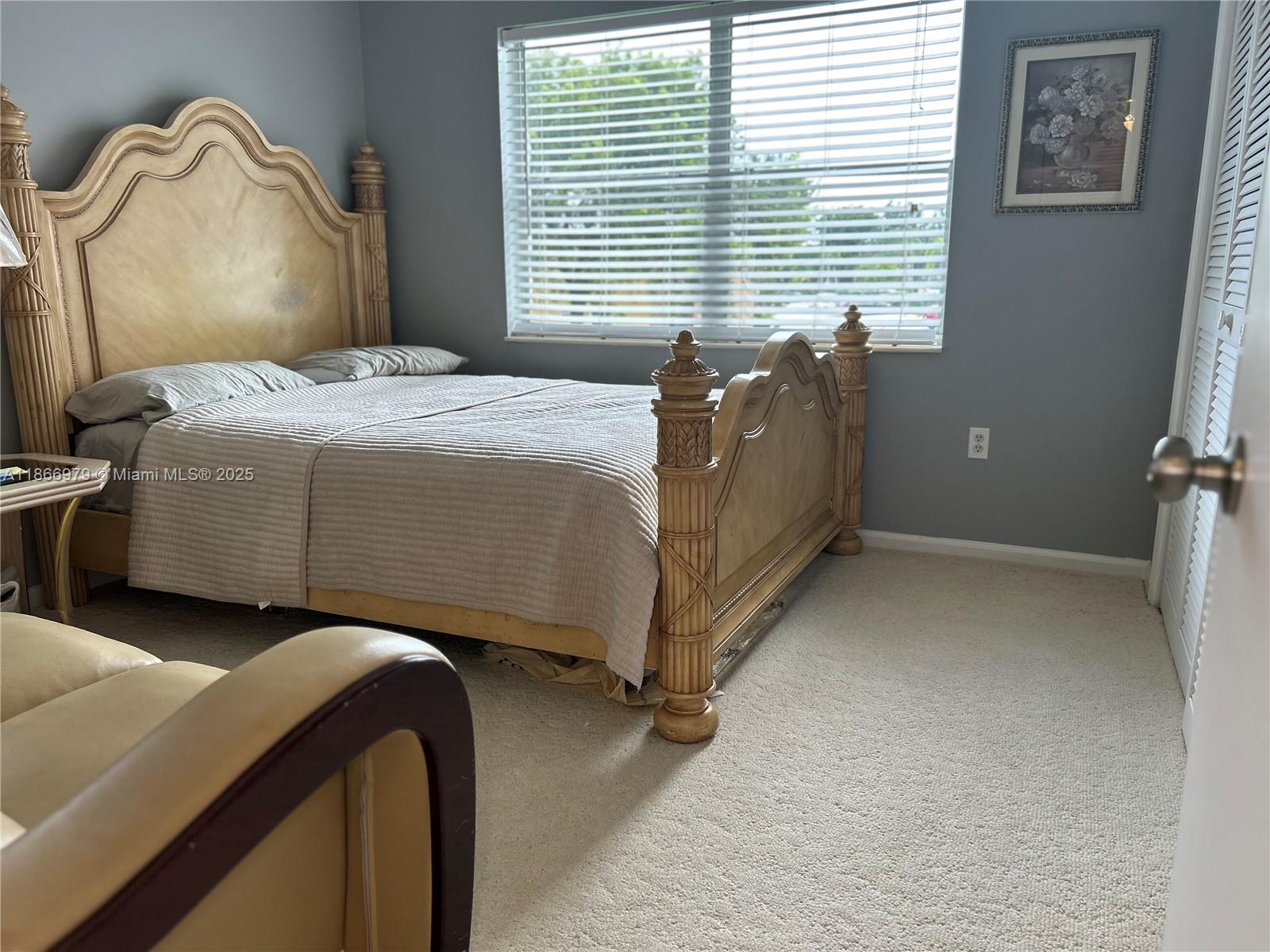 9802 Marina Boulevard, Unit 125 Boca Raton, FL 33428 - Photo 12 of 33 a bedroom with a bed and a window