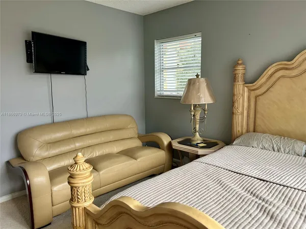 a bedroom with a bed and a flat screen tv