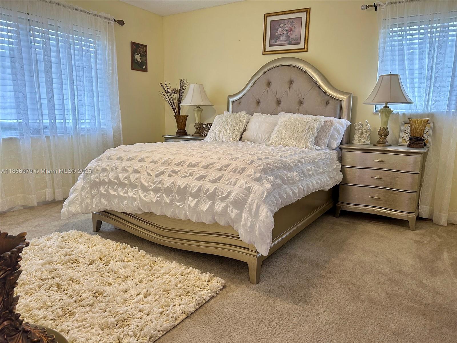 9802 Marina Boulevard, Unit 125 Boca Raton, FL 33428 - Photo 16 of 33 a bedroom with a bed and a window