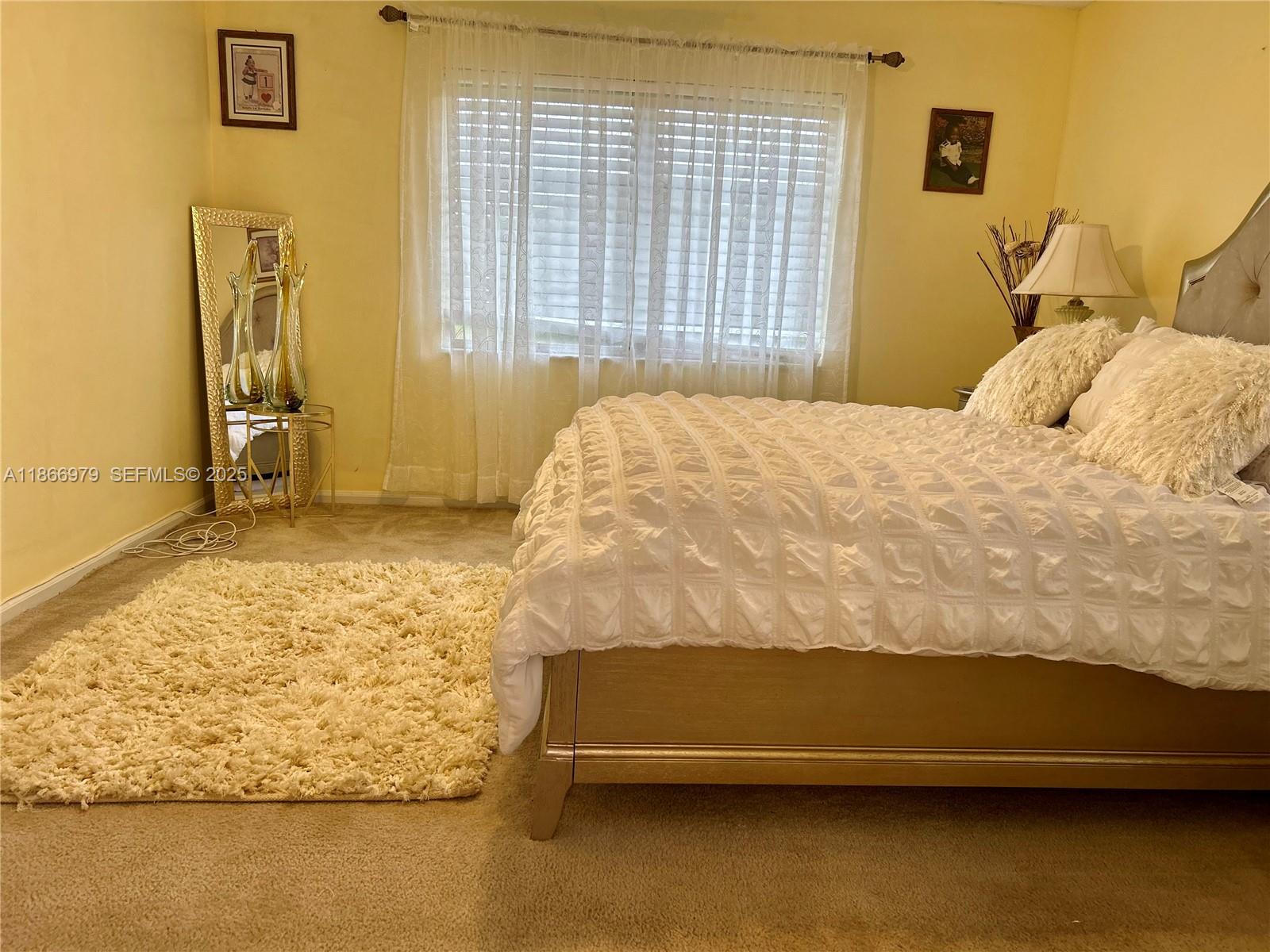9802 Marina Boulevard, Unit 125 Boca Raton, FL 33428 - Photo 20 of 33 a bedroom with a bed and a table