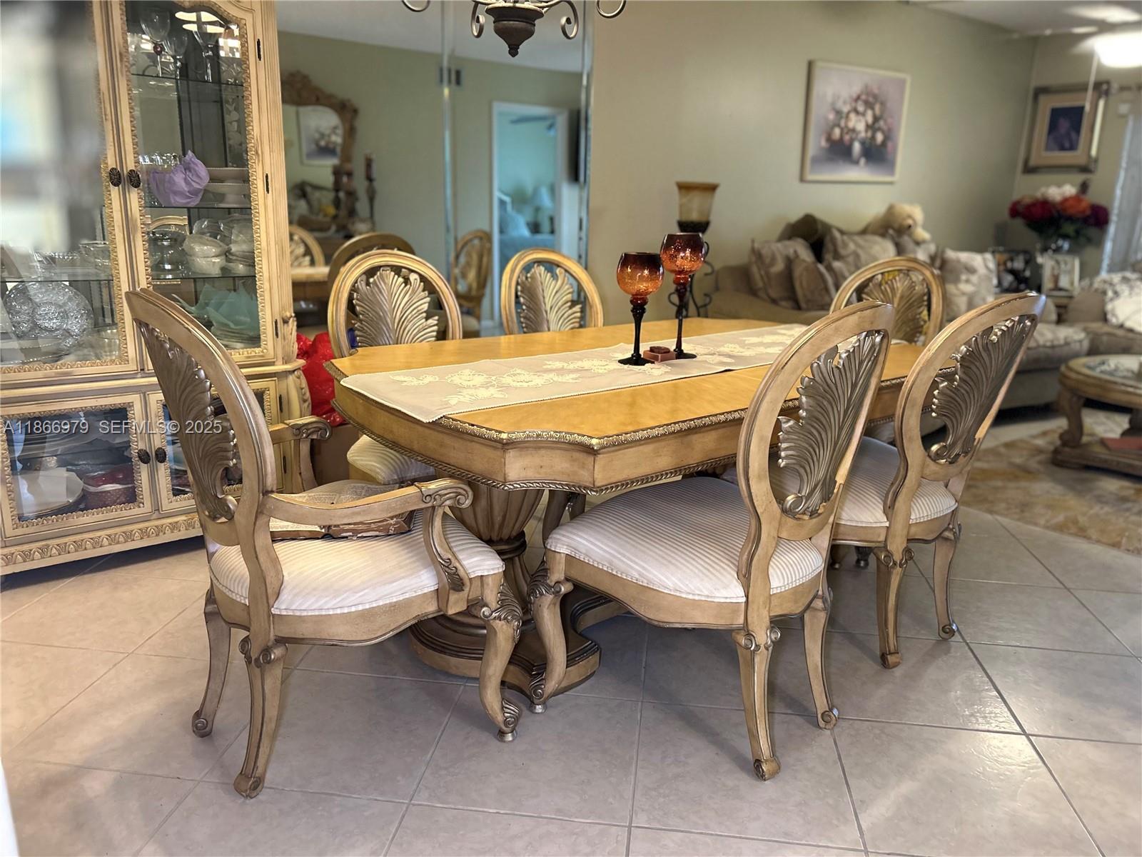 9802 Marina Boulevard, Unit 125 Boca Raton, FL 33428 - Photo 2 of 33 a view of a dining room kitchen with furniture and chandelier