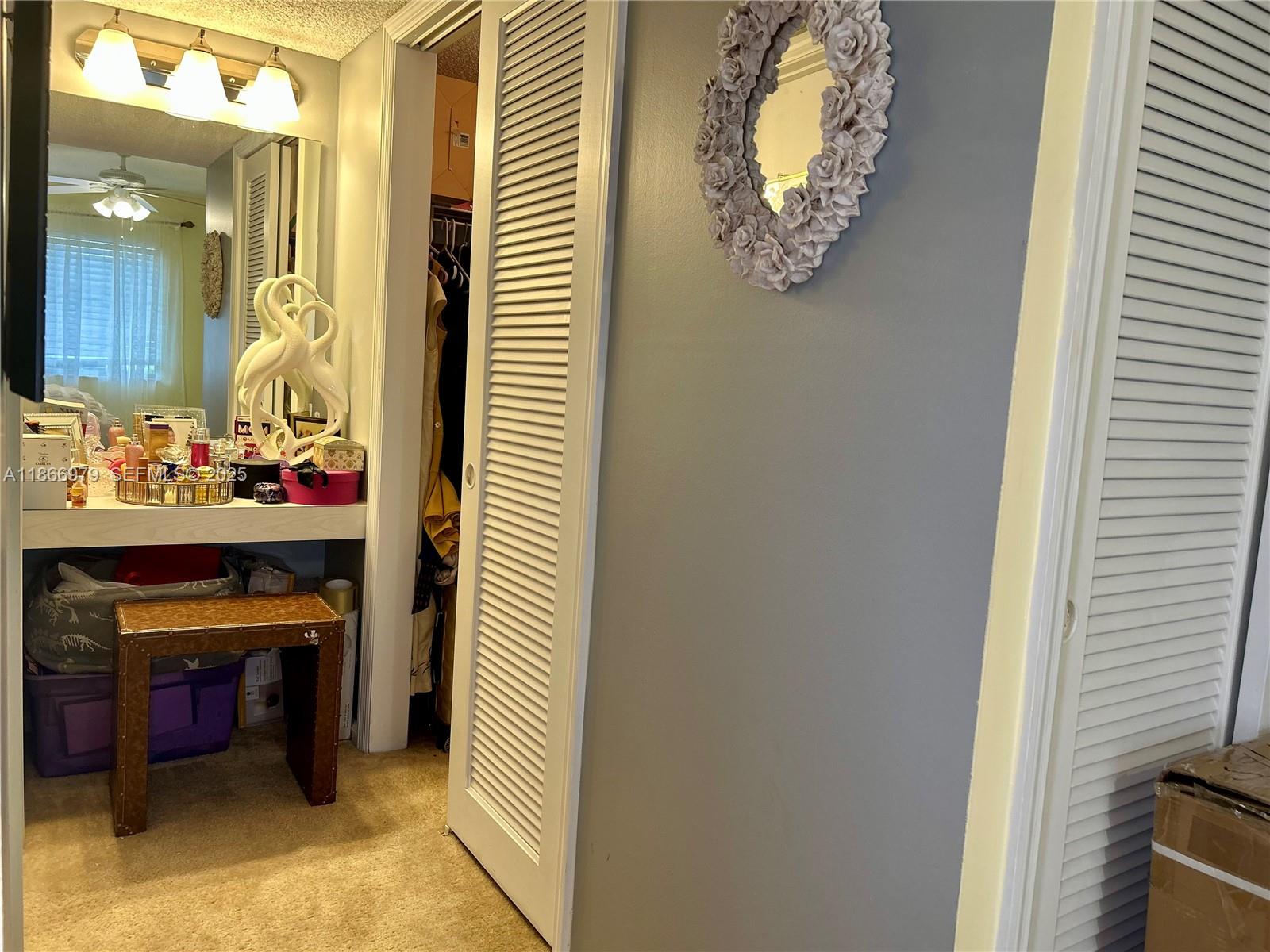 9802 Marina Boulevard, Unit 125 Boca Raton, FL 33428 - Photo 22 of 33 a room with a table and a mirror