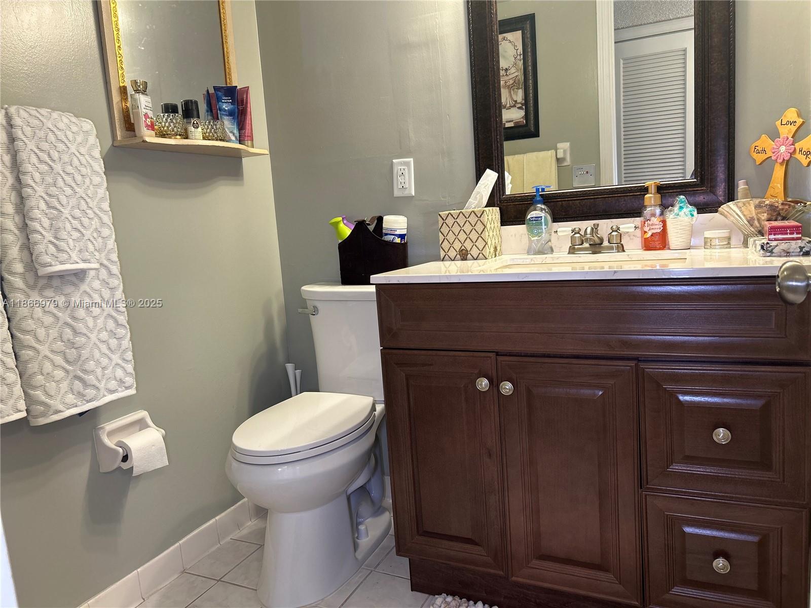 9802 Marina Boulevard, Unit 125 Boca Raton, FL 33428 - Photo 24 of 33 a bathroom with a sink and a toilet