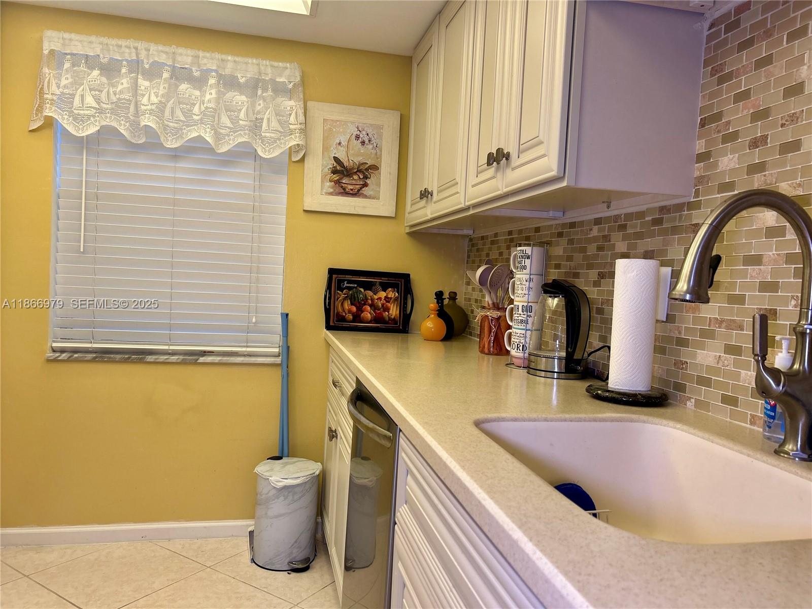 9802 Marina Boulevard, Unit 125 Boca Raton, FL 33428 - Photo 28 of 33 a kitchen with a sink and a stove