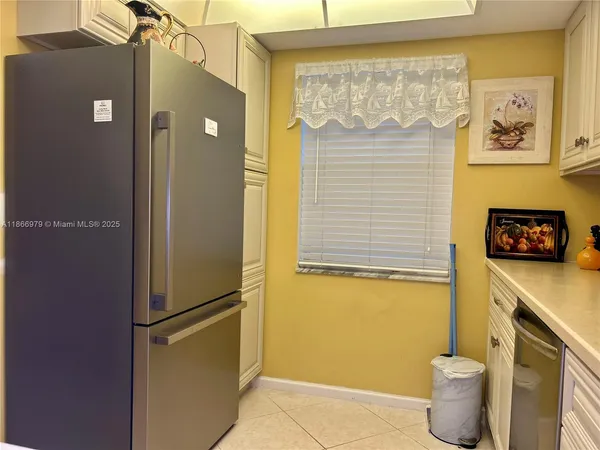 a kitchen with a refrigerator and a sink