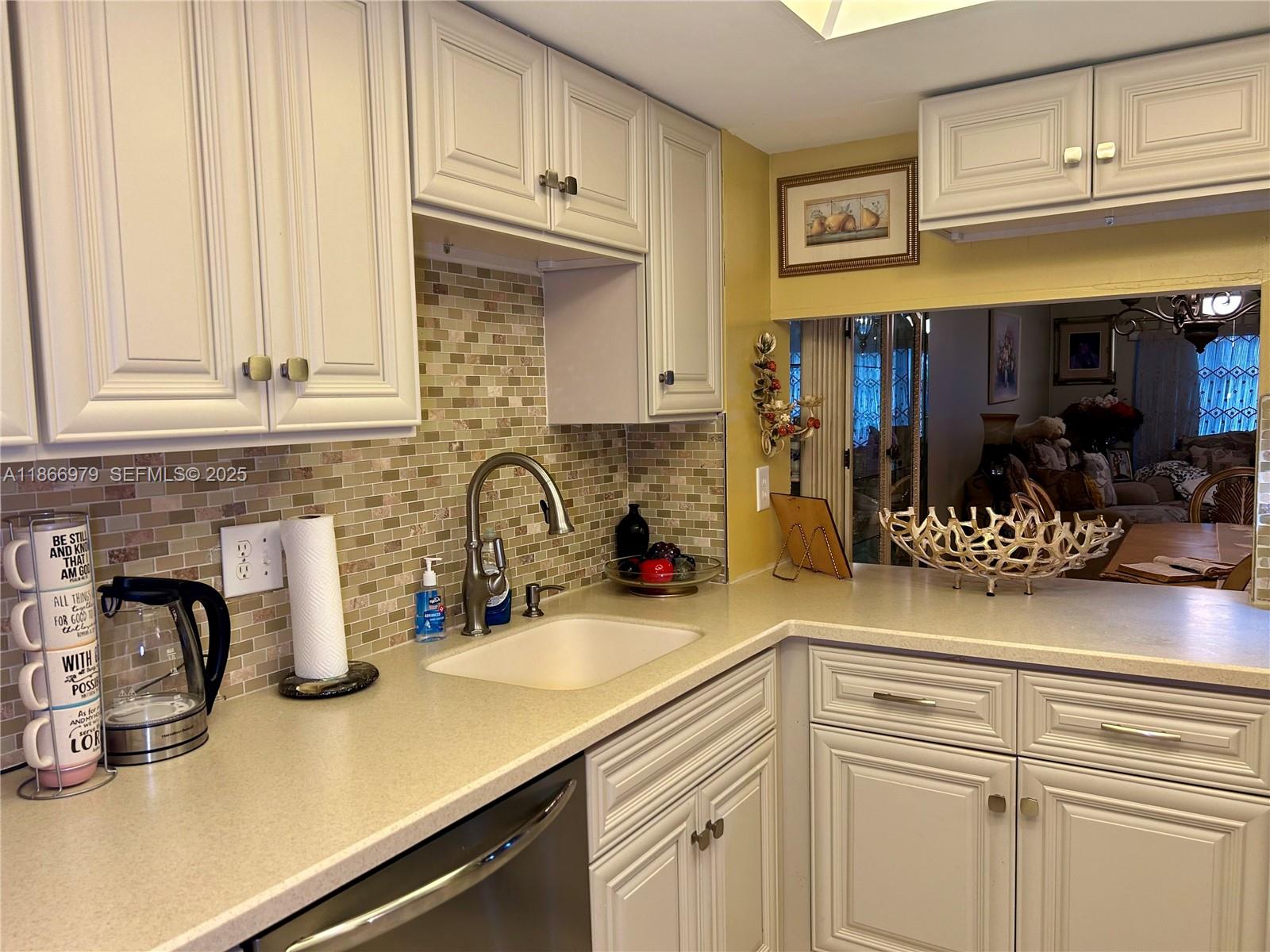9802 Marina Boulevard, Unit 125 Boca Raton, FL 33428 - Photo 30 of 33 a kitchen with stainless steel appliances granite countertop a sink and cabinets