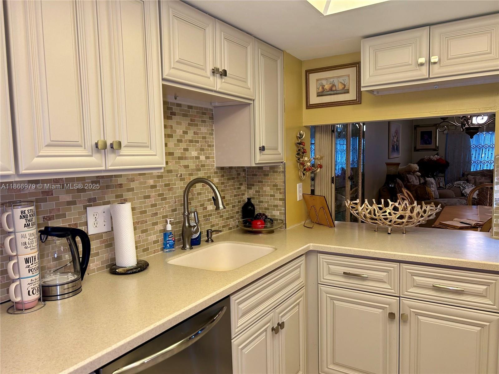 9802 Marina Boulevard, Unit 125 Boca Raton, FL 33428 - Photo 30 of 33 a kitchen with stainless steel appliances granite countertop a sink and cabinets