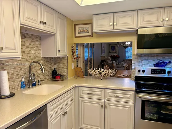 a kitchen with stainless steel appliances granite countertop a sink and cabinets
