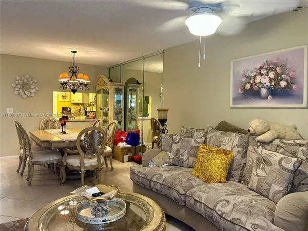 a living room with furniture and a chandelier