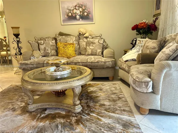 a living room with furniture and a sink
