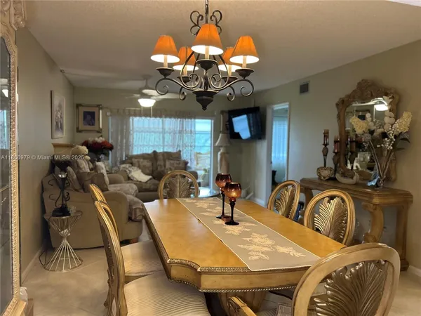 a view of a dining room with furniture and chandelier