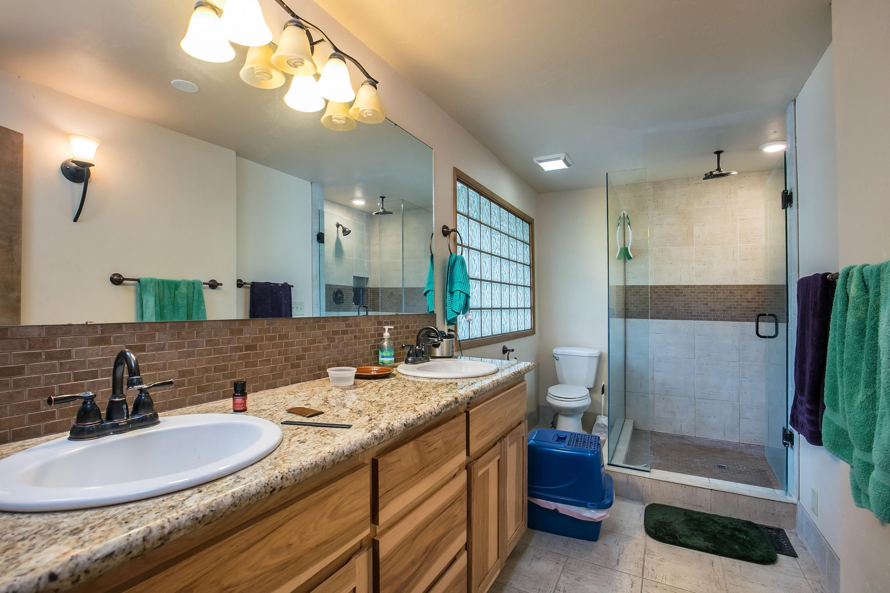 21133 Bear Creek Road Bend, OR 97702 - Photo 23 of 23 The master bath offers granite counters, a double vanity and step-in fully tiled shower with rain shower head.