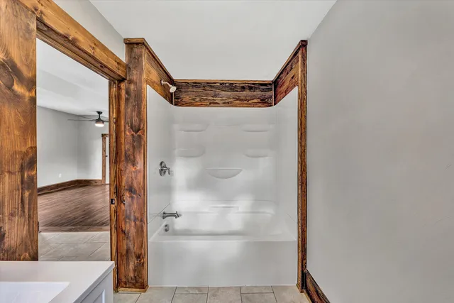 a bathroom with a glass shower door and mirror