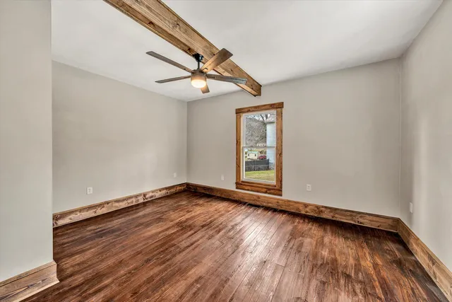 wooden floor in an empty room with a window