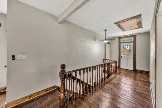 a view of hallway with wooden floor