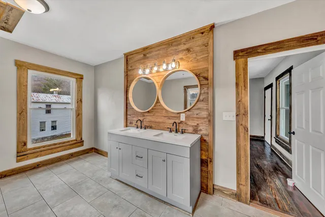 a view of a bathroom with mirror sink and glass door