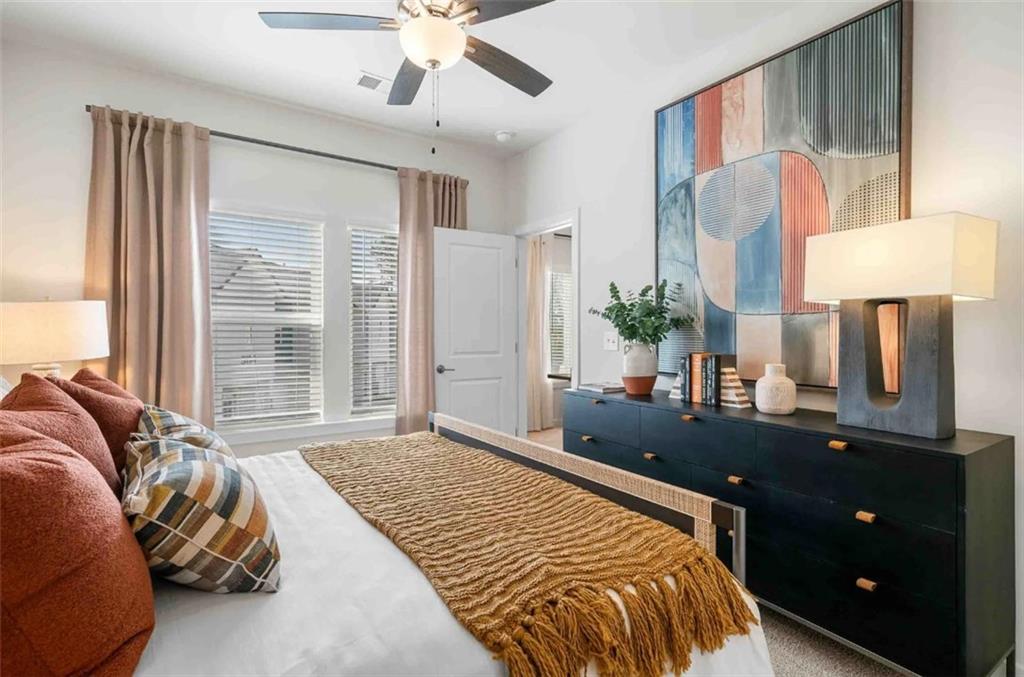 1450 Peachtree Industrial Boulevard, Unit 5109C Sugar Hill, GA 30518 - Photo 13 of 30 a bedroom with a large bed and a flat tv screen on dresser