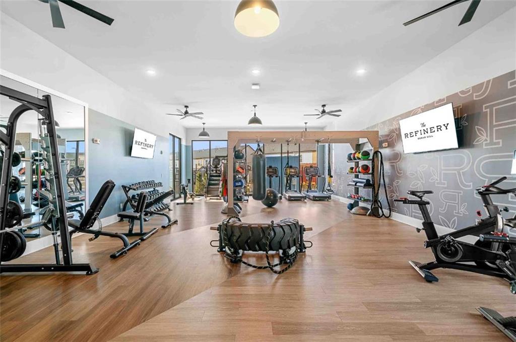 1450 Peachtree Industrial Boulevard, Unit 5109C Sugar Hill, GA 30518 - Photo 21 of 30 a view of a room with gym equipment and large windows