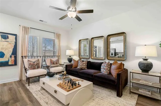 a living room with furniture a rug and a chandelier