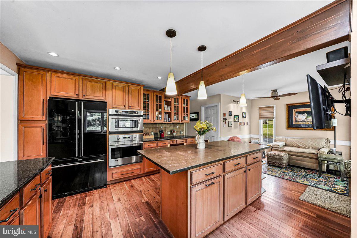 623 South Waterloo Road Devon, PA 19333 - Photo 11 of 31 a kitchen with stainless steel appliances granite countertop a refrigerator a stove and a wooden floors