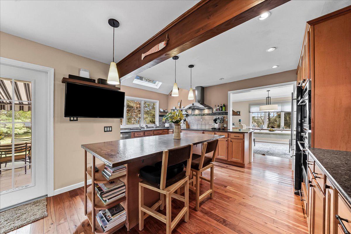623 South Waterloo Road Devon, PA 19333 - Photo 12 of 31 a kitchen with stainless steel appliances a dining table chairs refrigerator and microwave