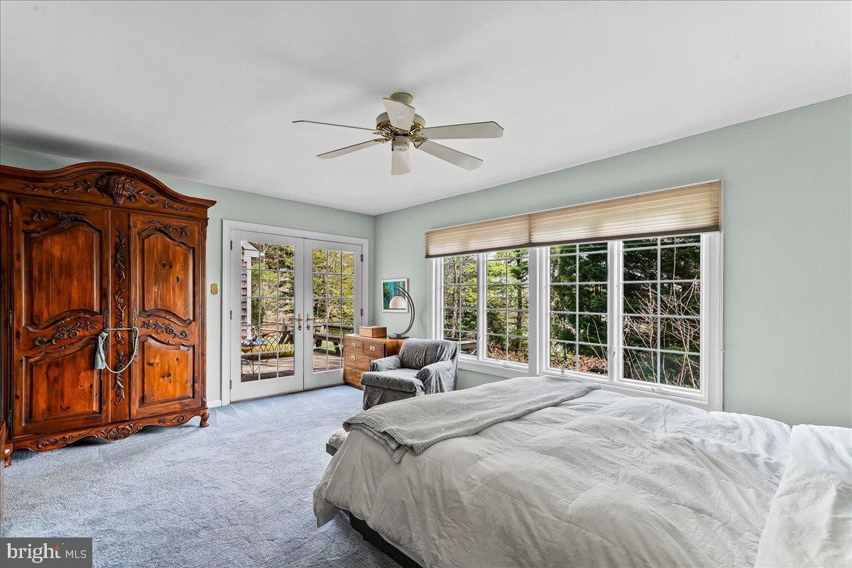 623 South Waterloo Road Devon, PA 19333 - Photo 19 of 31 a spacious bedroom with a bed and large windows