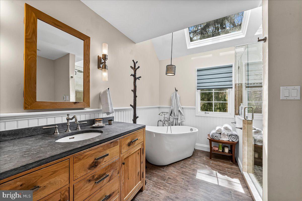 623 South Waterloo Road Devon, PA 19333 - Photo 21 of 31 a bathroom with a granite countertop sink and a mirror