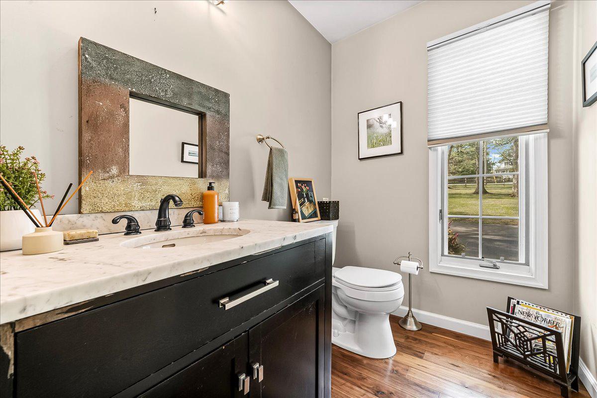 623 South Waterloo Road Devon, PA 19333 - Photo 23 of 31 a bathroom with a granite countertop toilet sink and mirror