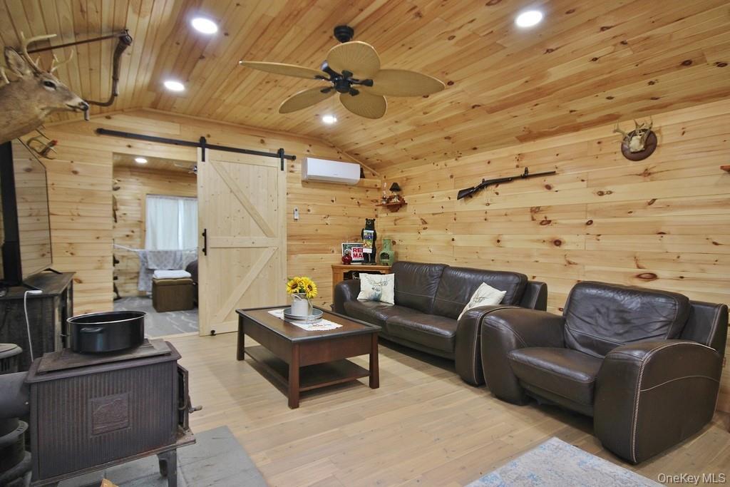 703 Dahlia Road Livingston Manor, NY 12758 - Photo 17 of 44 a living room with furniture and a ceiling fan