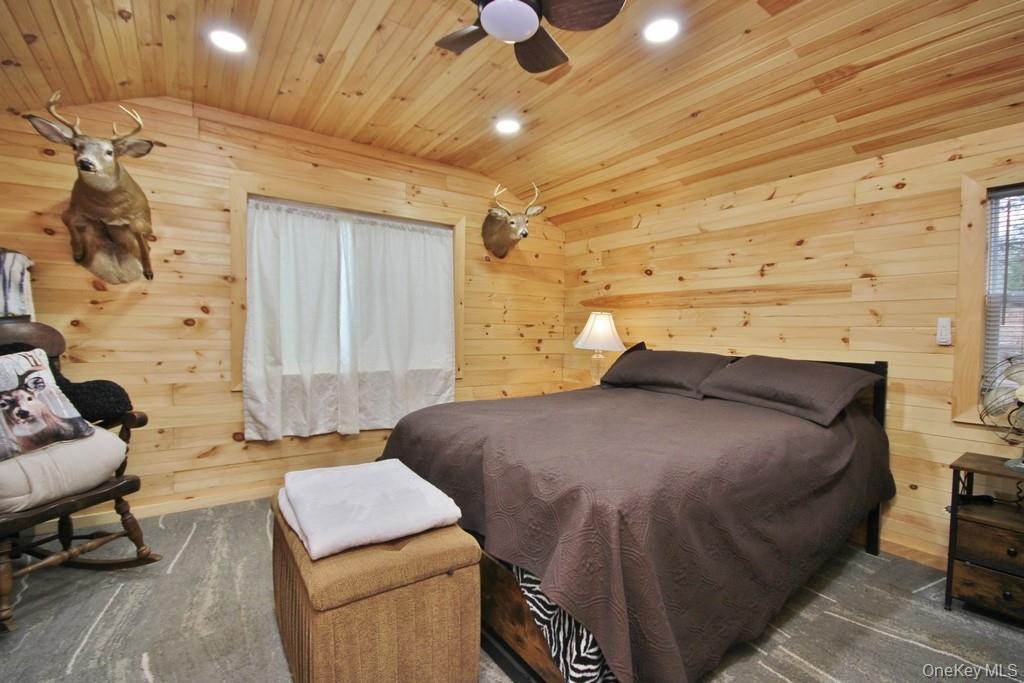 703 Dahlia Road Livingston Manor, NY 12758 - Photo 19 of 44 a bedroom with a bed and lamp