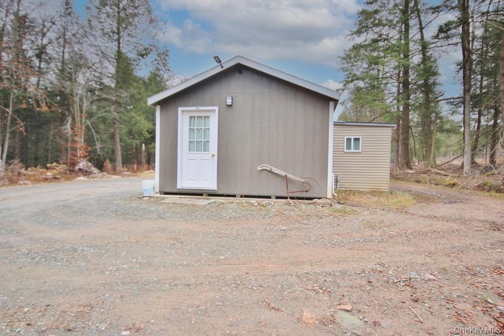 703 Dahlia Road Livingston Manor, NY 12758 - Photo 28 of 44 a wooden house with a outdoor space