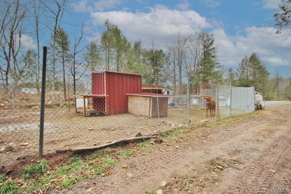703 Dahlia Road Livingston Manor, NY 12758 - Photo 35 of 44 a backyard of a house with oven and wooden fence