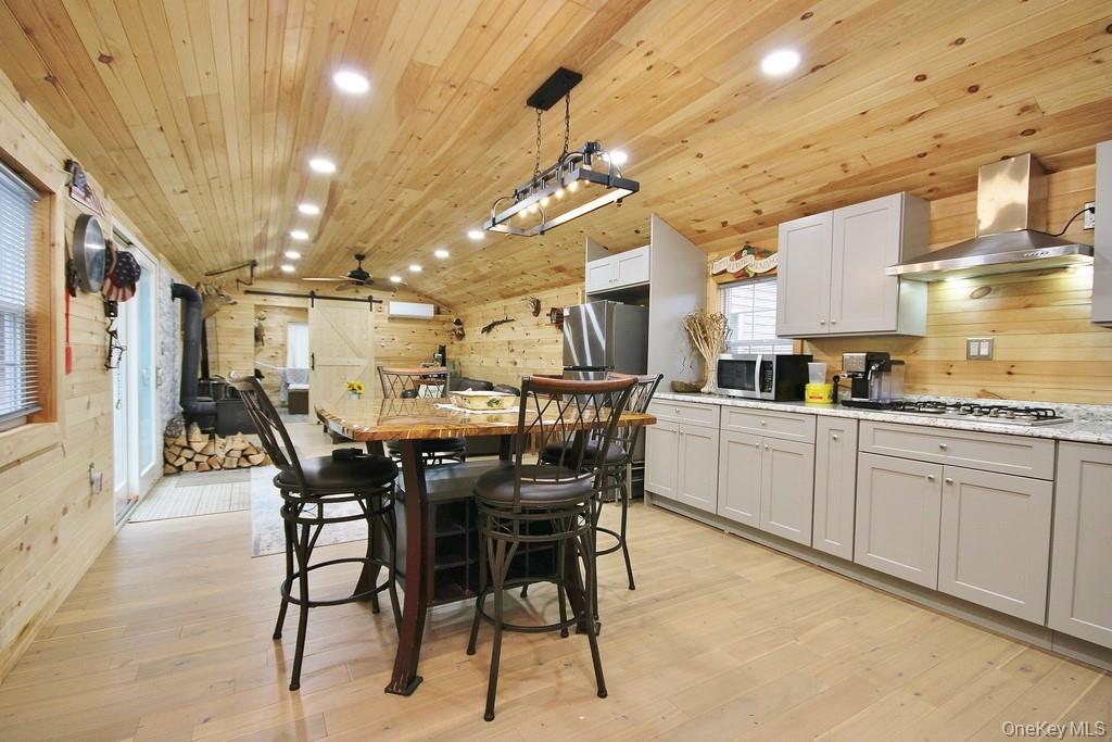 703 Dahlia Road Livingston Manor, NY 12758 - Photo 4 of 44 a kitchen with a table and chairs in it