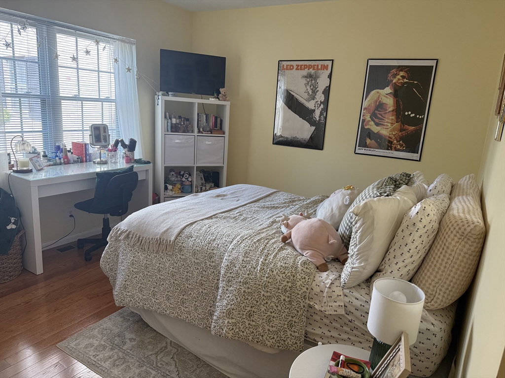 162 Lake Shore Road, Unit 2 Boston, MA 02135 - Photo 4 of 17 a bed room with a bed and a chair