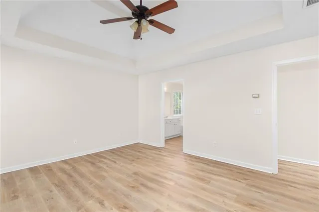 a view of a big room with wooden floor and closet in a room
