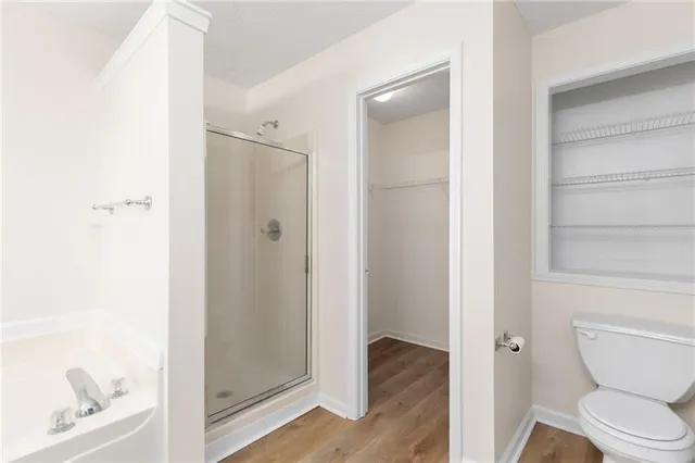 a bathroom with a toilet and a shower