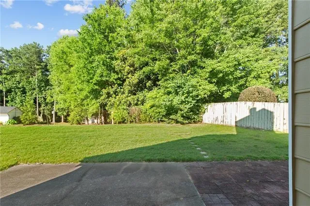 a view of a field with a trees in the background