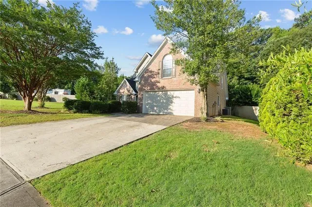 a view of a house with a yard and garage