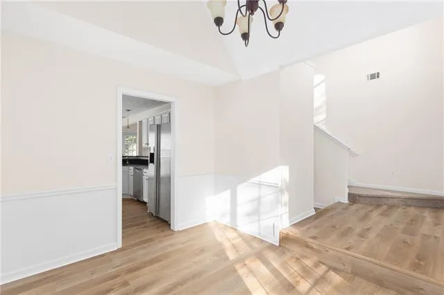 a view of entryway and hall with wooden floor