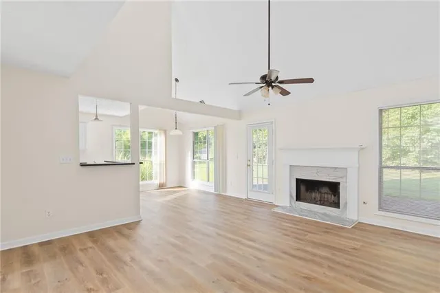 a view of an empty room with a fireplace and a window