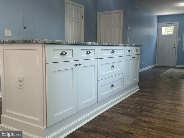 a living room with furniture or wooden floor and a large window