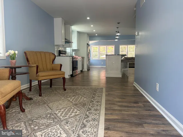 a lobby with furniture and a wooden floor