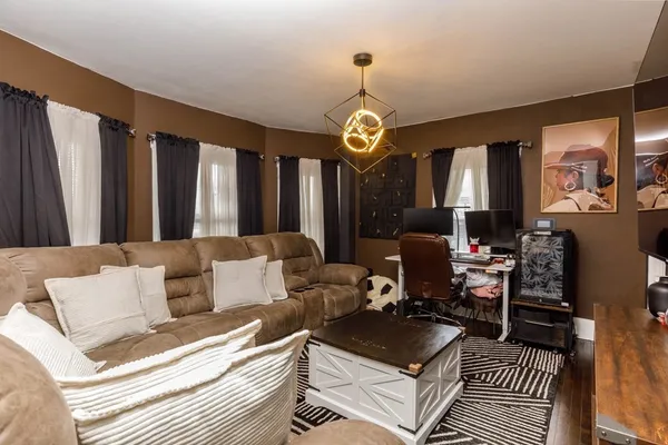 a living room with furniture and a chandelier