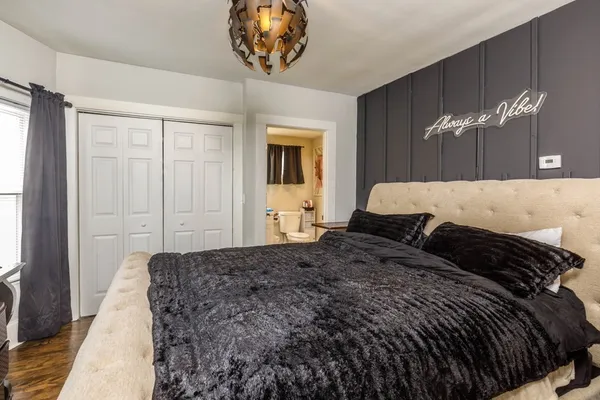a bedroom with a bed and a chandelier