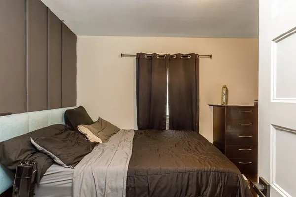 a bedroom with a bed and a dresser